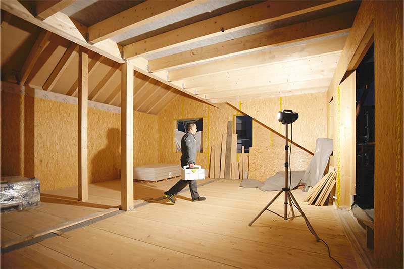 Прожектор осветява тъмна стая без прозорци